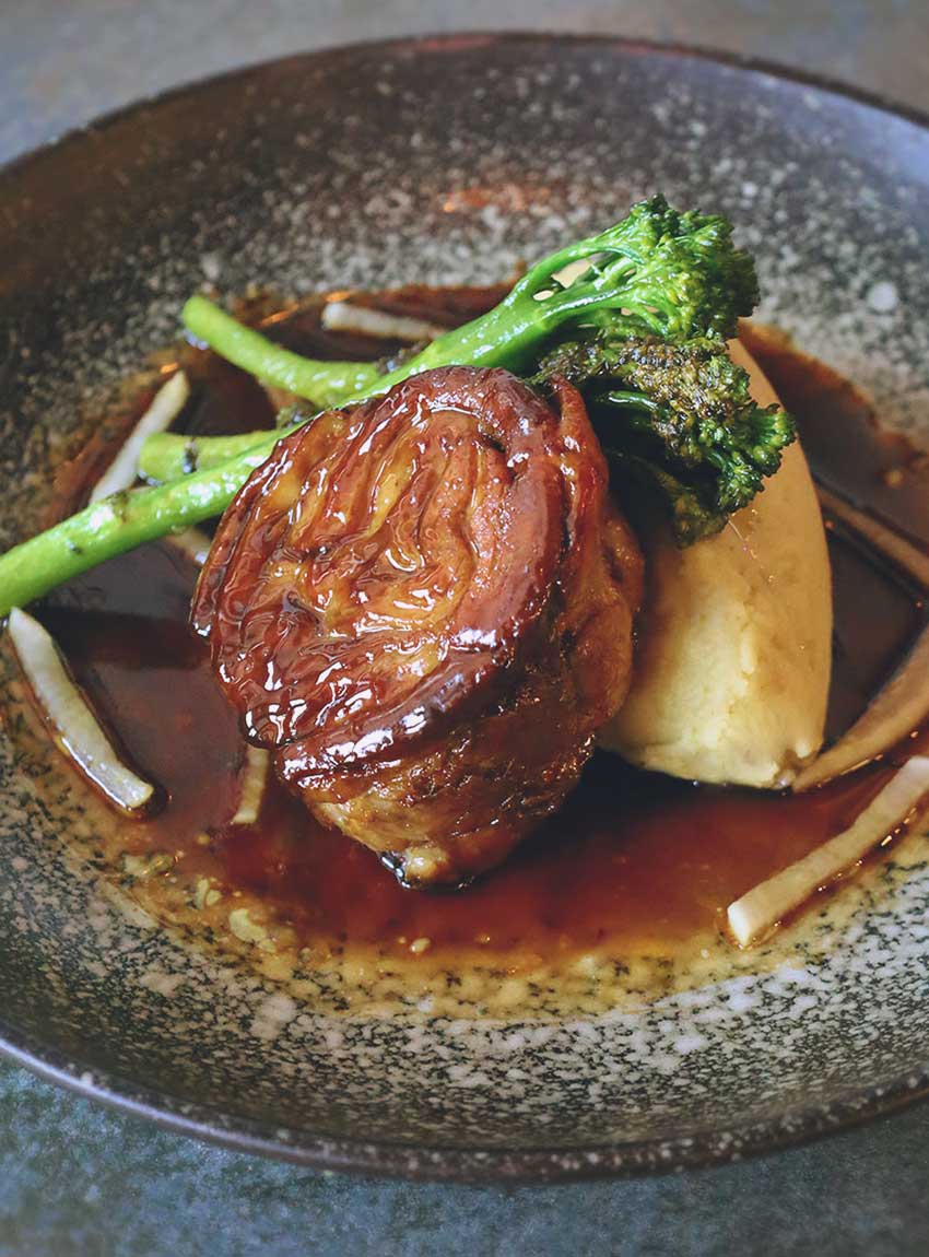 Slow cooked pork belly with Parmesan polenta, braised hispi cabbage and a Dijon mustard sauce.