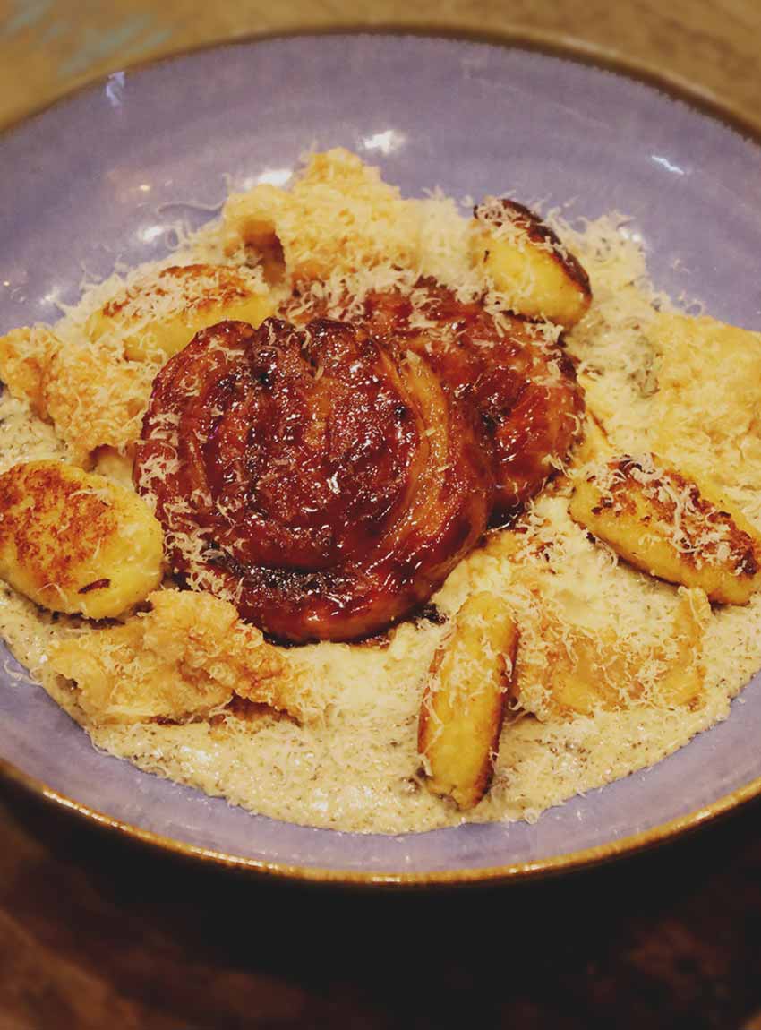 Pork belly with celeriac remoulade, gnocchi, black pudding, crackling, Dijon & parmesan sauce